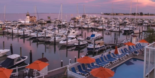 View from a balcony overlooking a marina at sunset.