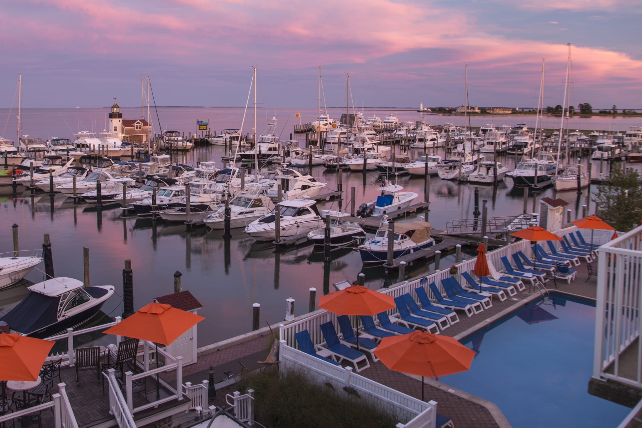 View from a balcony overlooking a marina at sunset.