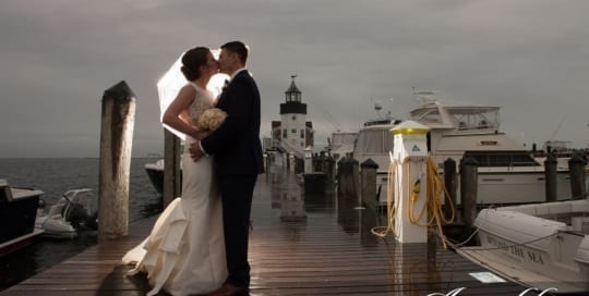 Bride and Groom kissing in front of the lighthouse.