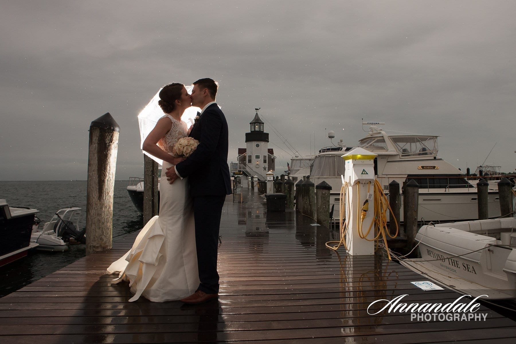 Bride and Groom kissing in front of the lighthouse.