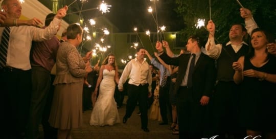 Wedding couple showered in sparklers.