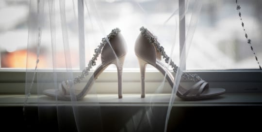 Jessica's wedding shoes on a windowsill.