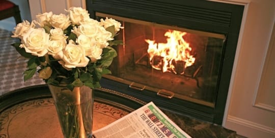 Flowers near fireplace.