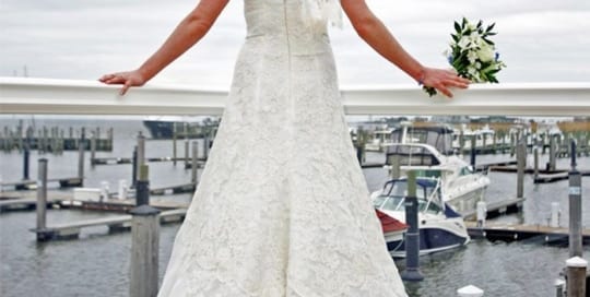 Bride looking out on harbor.